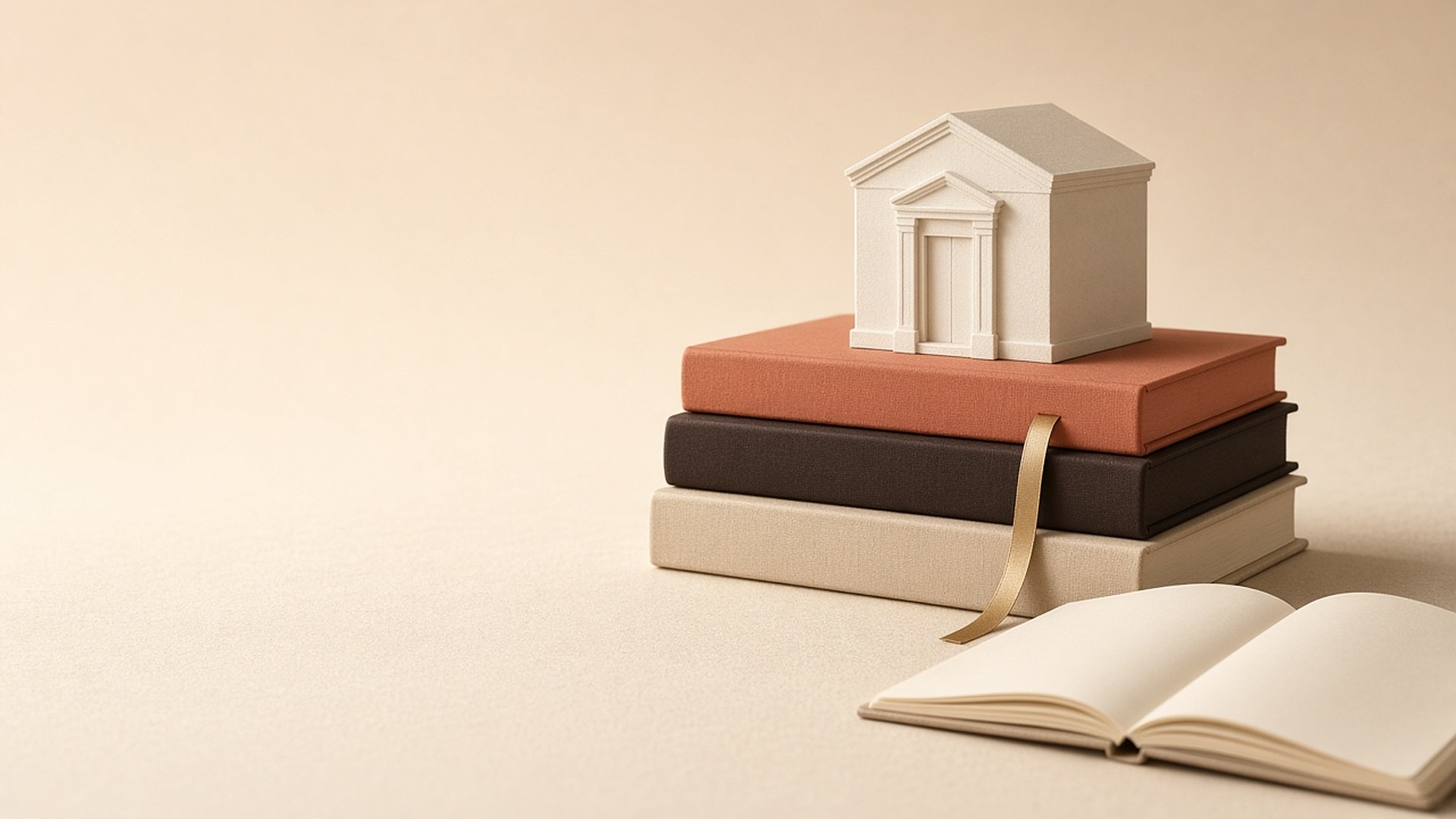 Stack of clothbound books topped with a small house model beside an open notebook
